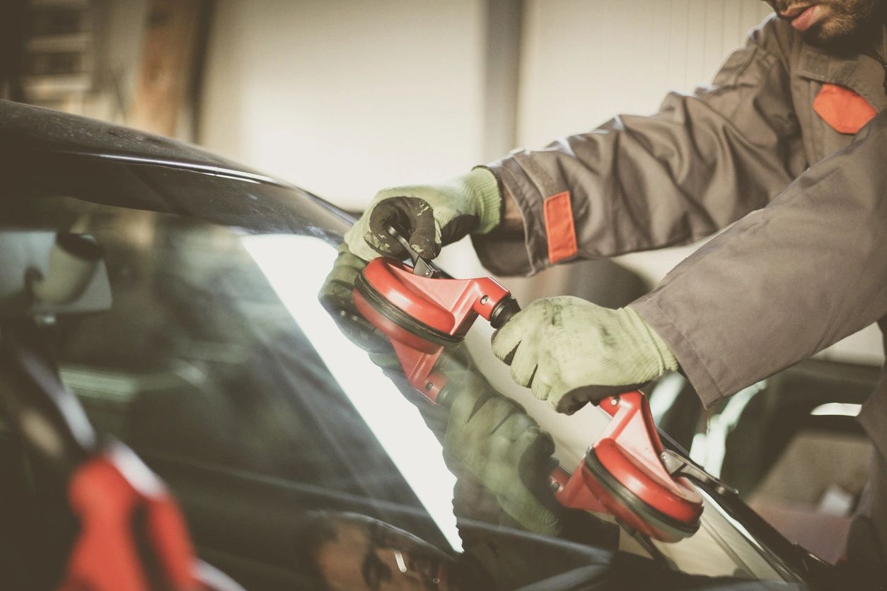 A person in gloves is working on a car.