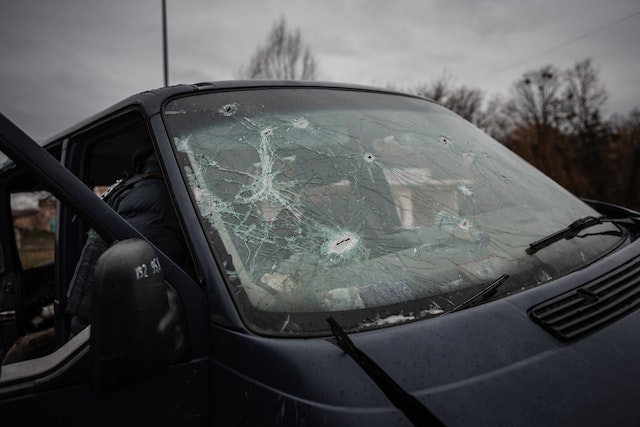 A car that has been smashed in the windshield.