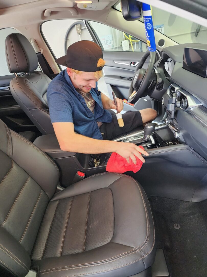 A man cleaning the interior of his car.